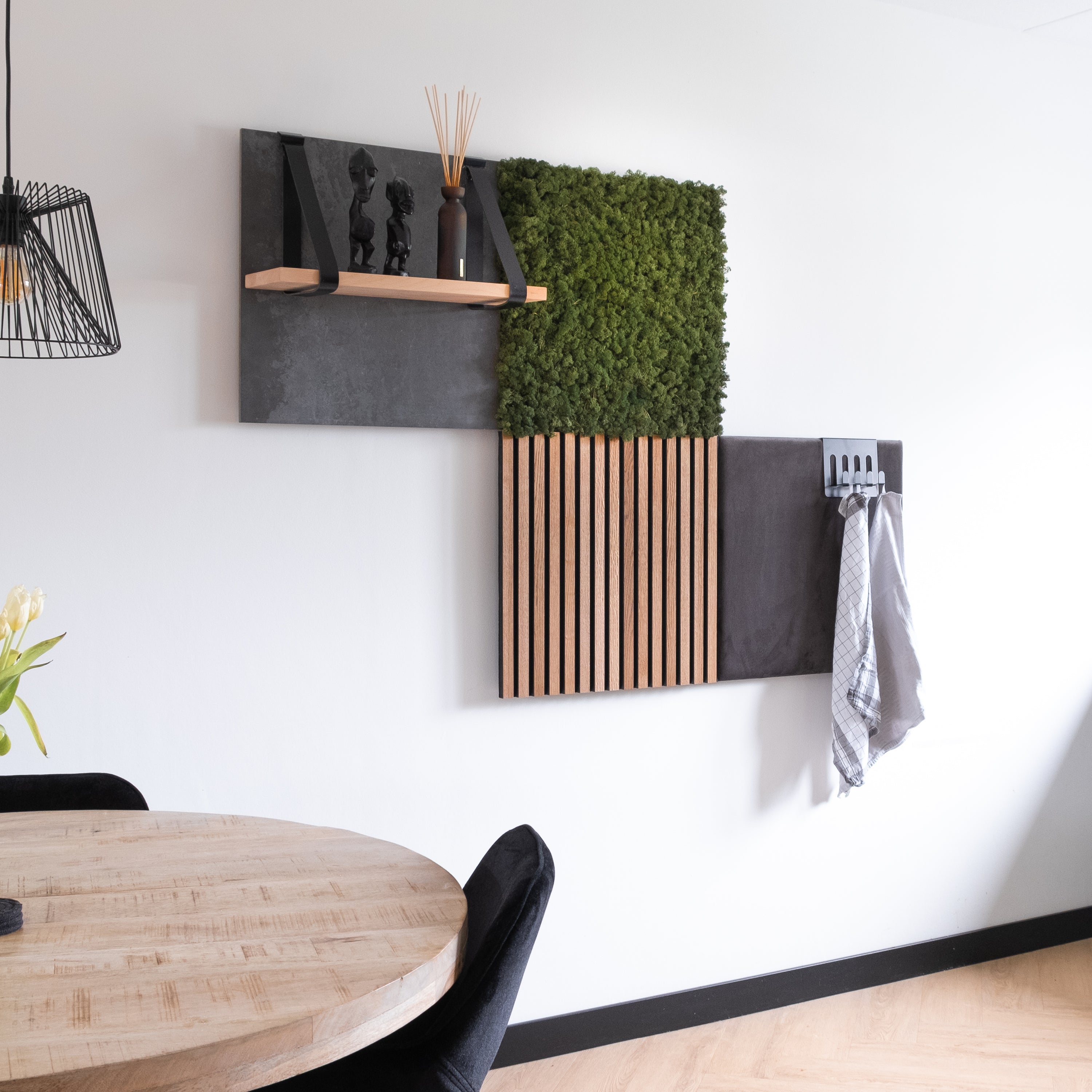 Akupanel wood slat acoustic wall panel mounted on white wall with moss square and shelf.
