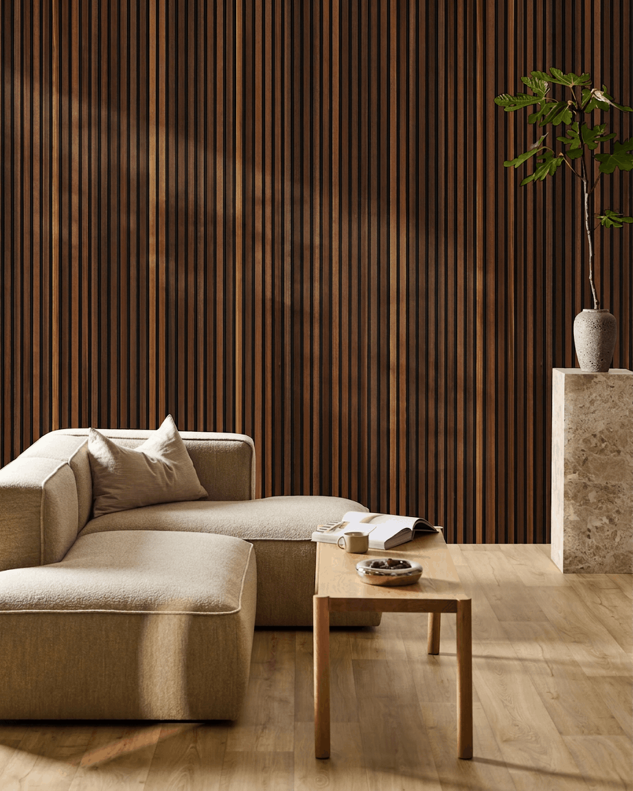Minimalistyczny salon z beige sofą, stolikiem kawowym z otwartą książką, wysoką rośliną oraz akustycznym drewnianym panelem WoodUpp Akupanel w kolorze smoked larch na ścianie.
