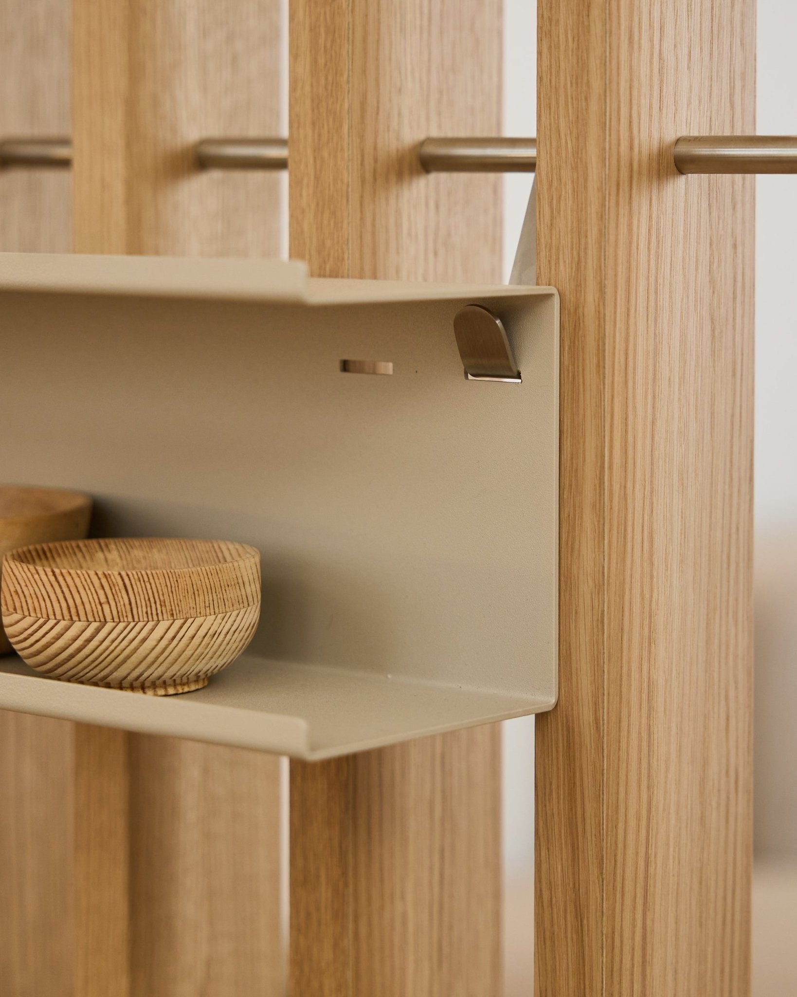 Zbliżenie na podwójną metalową półkę WoodUpp Nell / BM1 w kolorze beige, 63,5 cm, z plecionymi miskami i vertical nordyckimi drewnianymi lamelami akustycznymi osadzonymi na prętach steel.
